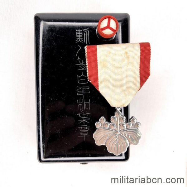 Japan. Order of the Rising Sun 8th Class of World War II. With lacquered wooden box and flap badge.